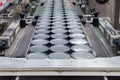 Aluminum cans for food processed in factory line conveyor machine at canned food manufacturing, selective focus