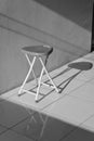 Aluminum chairs in black and white with harsh shadows. Loneliness and the concept of alienation