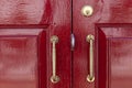 aluminum door handle and red wood door Royalty Free Stock Photo