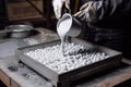 aluminum granule being poured into mold for casting