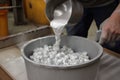 aluminum granule being poured into mold for casting