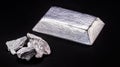 Aluminum ingot or bar next to aluminum ore, recycling or metal industry concept Royalty Free Stock Photo