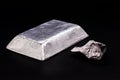 Aluminum ingot or bar next to aluminum ore, recycling or metal industry concept Royalty Free Stock Photo