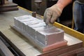 aluminum ingot being poured into mold for casting