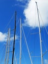 Aluminum masts, spars and rigging of the sailboat against the blue tropical sky. Boats and Navigation