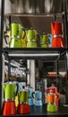 The aluminum moka coffee maker is an Italian standard. A Venetian shop window display shows bright colors of a new line.
