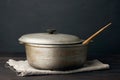 Aluminum old cauldron on a wooden table, kitchen utensils Royalty Free Stock Photo