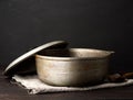 Aluminum old cauldron on a wooden table, kitchen utensils Royalty Free Stock Photo