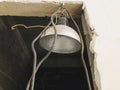 Aluminum old lamp, suspended on a brick wall in a new building. Repairs. Royalty Free Stock Photo