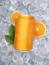 Aluminum orange soda can with fruits on ice cubes background