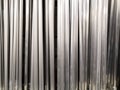 Aluminum pipes. Texture of metal pipes of the same diameter. The vertical arrangement of the elements.