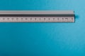 aluminum ruler on blue background