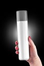 Aluminum spray can with plastic cap on hand with black background, isolated spray can on hand. Royalty Free Stock Photo