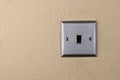 Aluminum switch plate on wall Royalty Free Stock Photo
