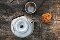 Aluminum teapot , cup and oatmeal cookies with chocolate on dry wooden table. Flat lay food. Picnic. Outdoor cooking. Kettle. Picn