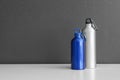 Aluminum water bottles for sports on gray background