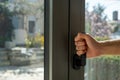 Aluminum window frame detail. Male hand opens the metal door closeup view Royalty Free Stock Photo