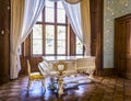 ALUPKA, RUSSIA - MAY 04, 2009: White Grand piano decorated with gilded bas-relief in the Victorian style living room