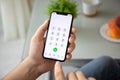 Man hand holding iPhone X with call number on screen Royalty Free Stock Photo