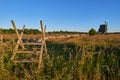 Alvar limestone moor with fence and mill at sunset