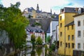 Alzette river crossing the old town of Luxembourg, Europe, with colorful typical houses and wall at the background