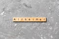 Alzheimer word written on wood block. Alzheimer text on cement table for your desing, concept