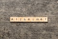 Alzheimer word written on wood block. Alzheimer text on cement table for your desing, concept Royalty Free Stock Photo