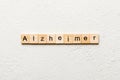 Alzheimer word written on wood block. Alzheimer text on cement table for your desing, concept