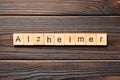 Alzheimer word written on wood block. Alzheimer text on wooden table for your desing, concept