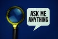 Top view of AMA Ask Me Anything text with magnifying glass on blue background Royalty Free Stock Photo