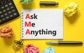 AMA ask me anything symbol. Concept words AMA ask me anything on white note on a beautiful yellow background. Calculator and pen. Royalty Free Stock Photo