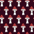 Amanitas seamless vector pattern. Red poisonous mushrooms. Hand-drawn illustration on dark background. Royalty Free Stock Photo