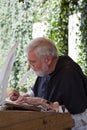 Amanuensis monk writing with his quill Royalty Free Stock Photo