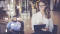 Amanuensis is standing, holding clipboard and recording information. In background, businessman is talking on his cell phone. Royalty Free Stock Photo