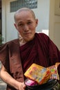 Amarapura, Myanmar - January 2020: Portrait of a buddhist monk with quizzical gaze looking straight into camera