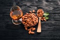 Amaretto Almond Liquor. Almond On a wooden background. Italian drink Top view. Royalty Free Stock Photo