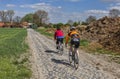 Amateur Cyclists on a Cobblestone Road