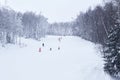 Amateur downhill skiers ride on a forest ski track in the Perm Krai, Russia