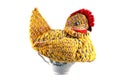 Amateur knitted hen on a tea brewing teapot