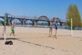 Amateur pairs play beach volleyball on a Dnipro river central beach in the same name city