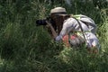 Amateur photographers in nature, surrounded by pets and insects on a sunny summer day, collecting photographic material for their