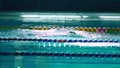 Amator female athlete doing butterfly stroke during training in indoor swimming pool, slow motion, full HD steady shot