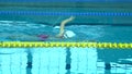 Amator swimmer practicing in water swimming pool.