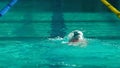 Amator swimmer practicing in water swimming pool.