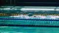 Amator swimmer practicing in water swimming pool.