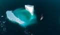 Amazaing top view iceberg and sailing boat. View from air. Drones view.