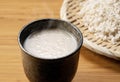 Amazake on the table and rice malt in a colander