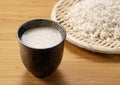 Amazake on the table and rice malt in a colander