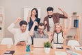 Amaze news! photo of happy young workers sitting and looking at laptop