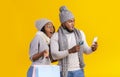 Amazed afro couple looking at smartphone, shopping online Royalty Free Stock Photo